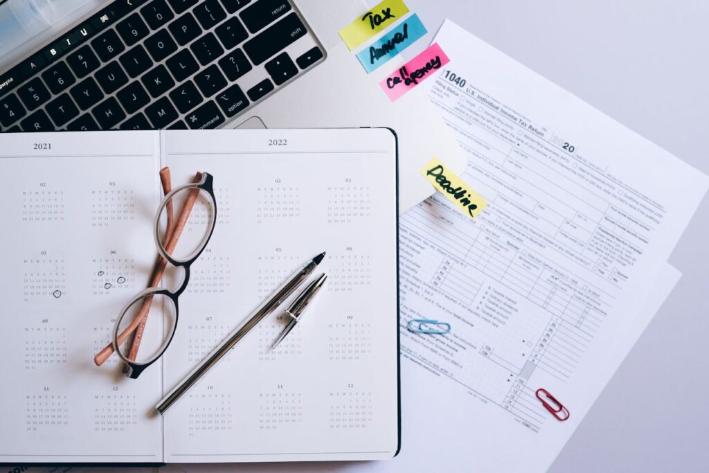 Organized workspace featuring a calendar, tax documents, and planner essentials.